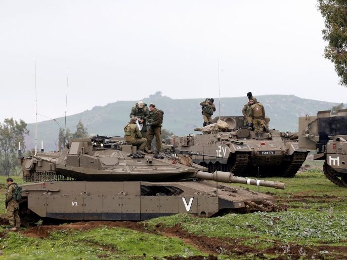 Israeli soldiers stand on top of a tank (front) and an armoured personnel carrier (APC) as they take part in an exercise in the Israeli-occupied Golan Heights, near the ceasefire line between Israel and Syria, March 20, 2017. REUTERS/Baz Ratner