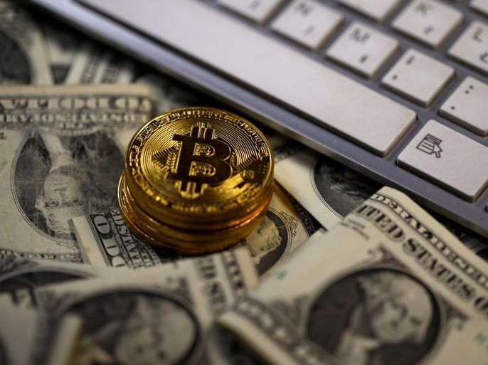 Bitcoin (virtual currency) coins placed on Dollar banknotes, next to computer keyboard, are seen in this illustration picture, November 6, 2017. REUTERS/Dado Ruvic/Illustration