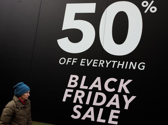 LONDON, ENGLAND - NOVEMBER 24: A woman walks past a Black Friday sale sign on Oxford Street on November 24, 2017 in London, England. British retailers offer deals on their products as part of the annual pre-Christmas Black Friday shopping event, held this year on November 24. (Photo by Jack Taylor/Getty Images)