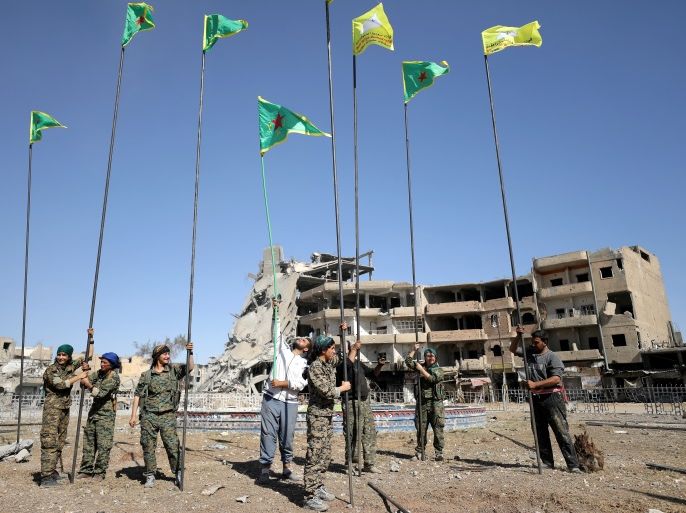 Fighters of Syrian Democratic Forces place flags at Naim Square after liberating Raqqa, Syria October 18, 2017. REUTERS/Rodi Said TPX IMAGES OF THE DAY
