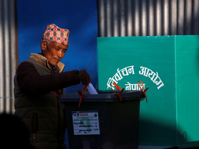 A man casts his vote in a ballot box during the parliamentary and provincial elections at Chautara in Sindhupalchok District November 26, 2017. REUTERS/Navesh Chitrakar
