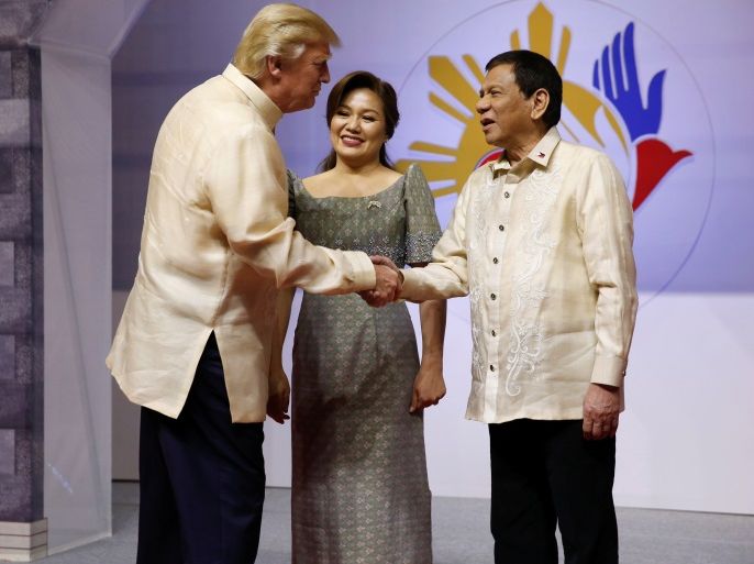 U.S. President Donald Trump shakes hands with Philippines President Rodrigo Duterte as he arrives for the gala dinner marking ASEAN's 50th anniversary in Manila, Philippines November 12, 2017. REUTERS/Jonathan Ernst
