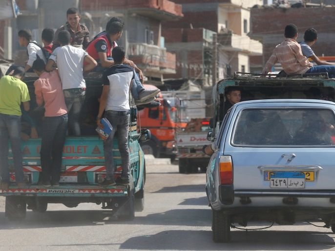 Students ride a pickup truck with other people in the province of Al-Sharkia in the northeast of Cairo, Egypt, October 17, 2016. REUTERS/Amr Abdallah Dalsh