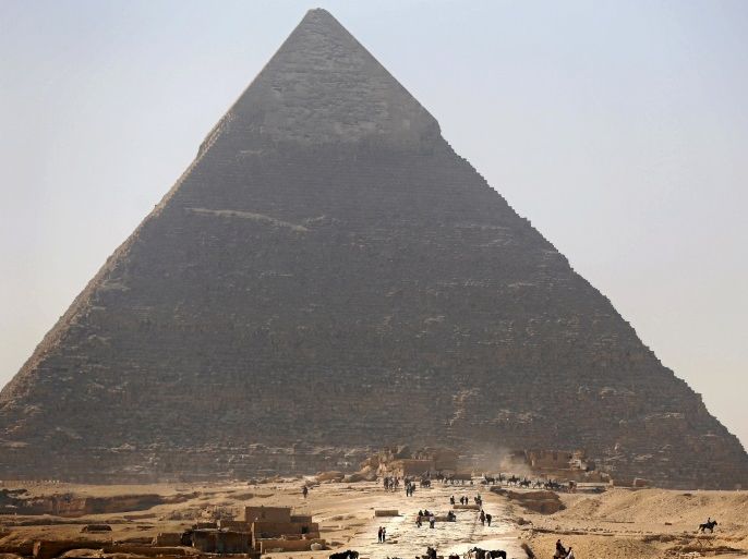 Tourists visit the Pyramid of Khufu, the largest of the Great Pyramids of Giza, on the outskirts of Cairo, Egypt, March 2, 2016. REUTERS/Amr Abdallah Dalsh