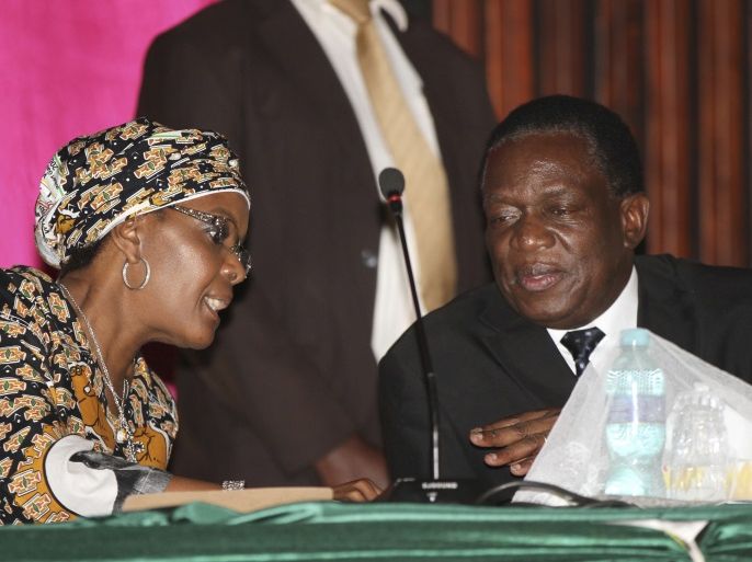 Grace Mugabe, wife of Zimbabwean President Robert Mugabe, talks to Deputy President Emmerson Mnangagwa (R) in Harare December 10, 2014. Mugabe appointed justice minister Mnangagwa as his new deputy on Wednesday, making the hardliner known as
