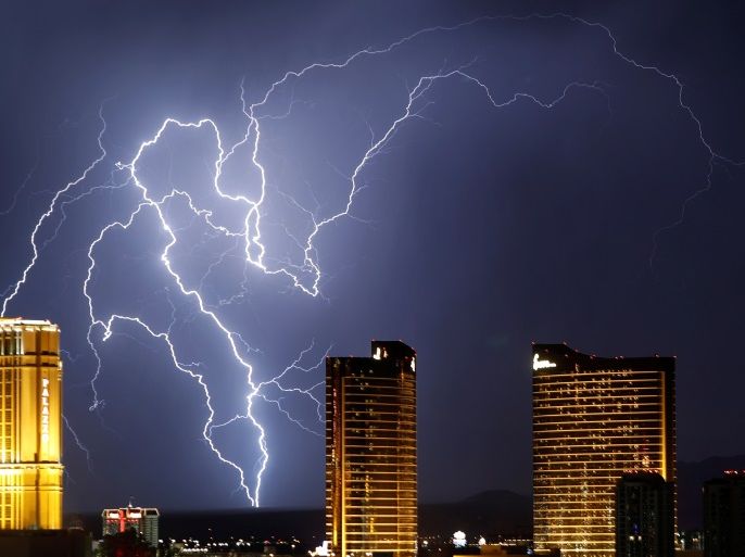 Lightning strikes behind Las Vegas Strip casinos as a thunderstorm passes through Las Vegas, Nevada, U.S. September 13, 2017. REUTERS/Steve Marcus