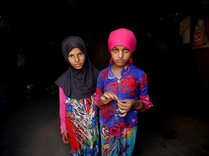 Saida Ahmed Baghili (R), 19, who is recovering from severe malnutrition, stands with her 12-year-old sister, Jalila, inside their family's hut in al-Tuhaita district of the Red Sea province of Hodeidah, Yemen, October 20, 2017. REUTERS/Abduljabbar Zeyad SEARCH