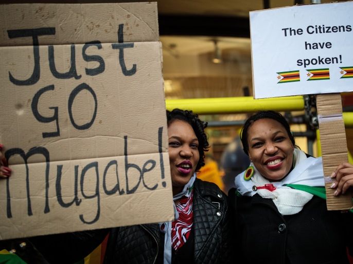 LONDON, ENGLAND - NOVEMBER 18: Protesters demonstrate outside the Embassy of Zimbabwe in London to call on the leader of the country Robert Mugabe to resign on November 18, 2017 in London, England. 93-year-old Mr Mugabe has been under house arrest following a military takeover in Zimbabwe with generals urging him to resign. (Photo by Jack Taylor/Getty Images)