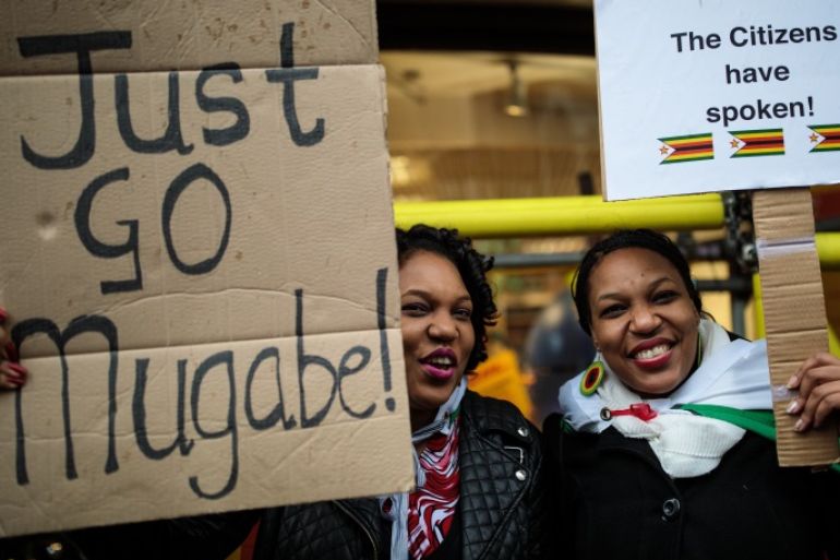 LONDON, ENGLAND - NOVEMBER 18: Protesters demonstrate outside the Embassy of Zimbabwe in London to call on the leader of the country Robert Mugabe to resign on November 18, 2017 in London, England. 93-year-old Mr Mugabe has been under house arrest following a military takeover in Zimbabwe with generals urging him to resign. (Photo by Jack Taylor/Getty Images)