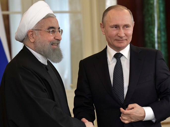 Russian President Vladimir Putin shakes hands with Iranian President Hassan Rouhani during a joint news conference following their meeting at the Kremlin in Moscow, Russia March 28, 2017. Sputnik/Aleksey Nikolskyi/Kremlin via REUTERS ATTENTION EDITORS - THIS IMAGE WAS PROVIDED BY A THIRD PARTY. EDITORIAL USE ONLY.