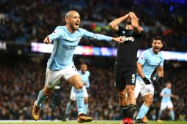 MANCHESTER, ENGLAND - DECEMBER 03: David Silva of Manchester City celebrates scoring his sides second goal while Pablo Zabaleta of West Ham United looks dejected during the Premier League match between Manchester City and West Ham United at Etihad Stadium on December 3, 2017 in Manchester, England. (Photo by Clive Brunskill/Getty Images)