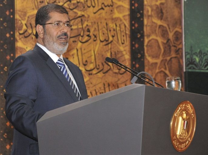 Egypt's President Mohamed Morsi speaks during the Laylat al-Qadr at Egypt Al-Azhar Conference Center in Nasr City in Cairo August 12, 2012. Mursi dismissed Cairo's two top generals and quashed a military order that had curbed the new leader's powers, in a move that further stamped his authority on the country and its army. REUTER/Handout (EGYPT - Tags: POLITICS) FOR EDITORIAL USE ONLY. NOT FOR SALE FOR MARKETING OR ADVERTISING CAMPAIGNS. THIS IMAGE HAS BEEN SUPPLIED BY A THIRD PARTY. IT IS DISTRIBUTED, EXACTLY AS RECEIVED BY REUTERS, AS A SERVICE TO CLIENTS