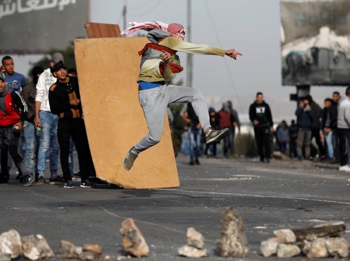 A Palestinian demonstrator hurls stones towards Israeli troops during clashes at a protest against U.S. President Donald Trump's decision to recognise Jerusalem as the capital of Israel, near the West Bank city of Nablus, December 29, 2017. REUTERS/Mohamad Torokman