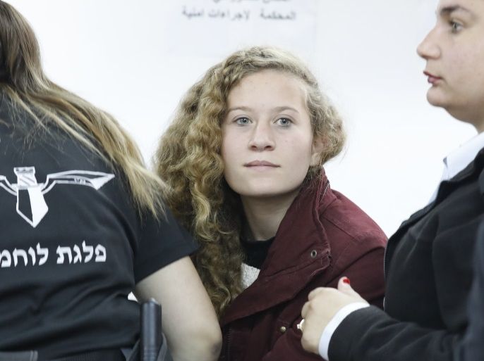 epa06399700 17 year old Palestinian Ahed Tamimi (C), a campaigner against Israel's occupation, appears at a military court at the Israeli-run Ofer prison in the West Bank village of Betunia, 20 December 2017.