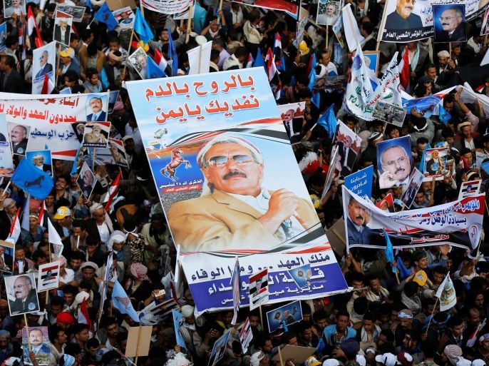 Supporters of Yemen's former President Ali Abdullah Saleh carry his poster during a rally to mark the 35th anniversary of the establishment of the General People's Congress party which is led by Saleh in Sanaa, Yemen August 24, 2017. The poster reads: