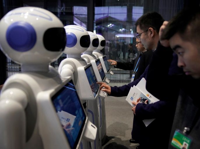 People look at Xiao Qiao robots during the fourth World Internet Conference in Wuzhen, Zhejiang province, China, December 3, 2017. REUTERS/Aly Song