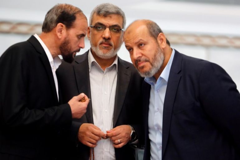 Hamas leaders Izzat Reshiq (C) and Khalil al-Hayya (R) chat during a reconciliation deal signing ceremony in Cairo, Egypt, October 12, 2017. REUTERS/Amr Abdallah Dalsh
