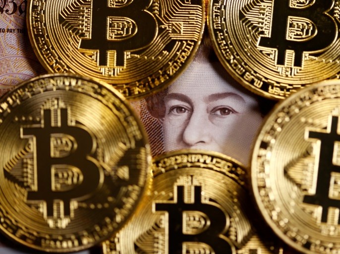 Bitcoins and a ten pound note are seen in this illustration picture taken September 27, 2017. REUTERS/Dado Ruvic/Illustration