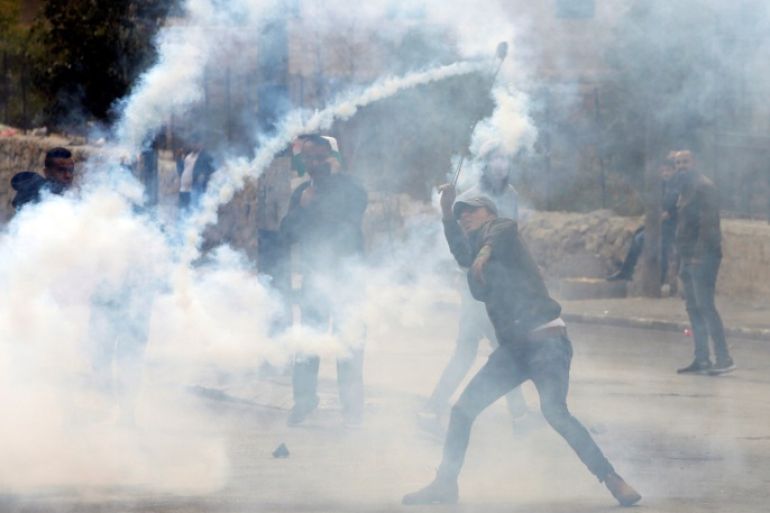 A Palestinian demonstrator uses a sling to hurl back a tear gas canister fired by Israeli troops during clashes at a protest against U.S. President Donald Trump's decision to recognize Jerusalem as the capital of Israel, in the West Bank city of Bethlehem December 20, 2017. REUTERS/Mussa Qawasma