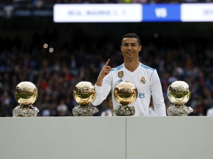 MADRID, SPAIN - DECEMBER 09: Cristiano Ronaldo of Real Madrid CF poses with his five Golden Ball (Ballon d'Or) trophies prior to start the La Liga match between Real Madrid CF and Sevilla FC at Estadio Santiago Bernabeu on December 9, 2017 in Madrid, Spain . (Photo by Gonzalo Arroyo Moreno/Getty Images)