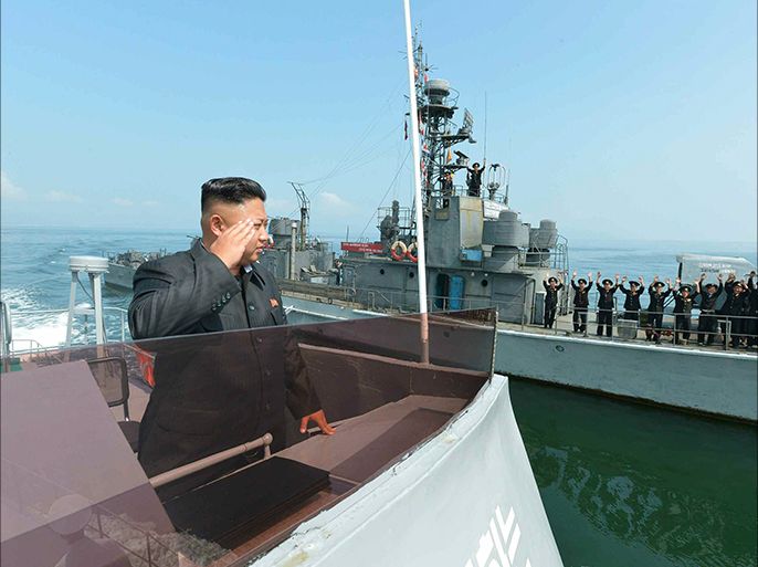 epa04299993 An undated picture released by the Rodong Sinmun, the newspaper of the ruling North Korean Workers Party on 05 July 2014 shows North Korean leader Kim Jong-un saluting to military servicemen on a Navy ship, somewhere in North Korean waters, after inspecting a military landing drill participated by the People's Army's ground, naval, air and anti-air forces. EPA/Rodong Sinmun SOUTH KOREA OUT