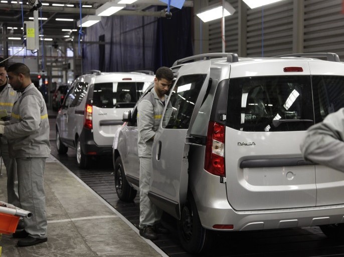 Employees work at the assembly line of Dacia Sandero cars at a factory operated by Somaca in Tangiers, February 21, 2013. Somaca is part of an expanding web of car makers and parts suppliers in Morocco, a heavily agricultural country which hopes to use the auto sector to expand its industrial base. A strong auto industry, exporting cars to Europe, North Africa and further afield, could help to resolve one of the country's main economic weaknesses, its external deficits. Morocco posted a trade deficit of $5.3 billion in the first three months of 2013, and last year obtained a $6.2 billion precautionary credit line from the International Monetary Fund in case of further pressure on its foreign reserves. Picture taken February 21, 2013. To match story MOROCCO-AUTO/INDUSTRY REUTERS/Stringer (MOROCCO - Tags: BUSINESS TRANSPORT)