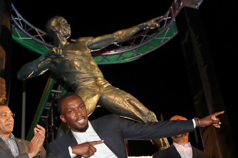 Olympic champion Usain Bolt (C) poses after the unveiling of his statue at the Statue Park at the National Stadium, in Kingston, Jamaica December 3, 2017. REUTERS/Gilbert Bellamy