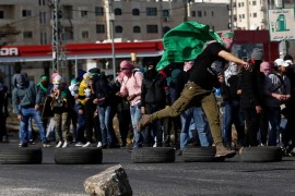 A Palestinian demonstrator hurls stones at Israeli troops during clashes at a protest against U.S. President Donald Trump's decision to recognize Jerusalem as the capital of Israel, near the Jewish settlement of Beit El, near the West Bank city of Ramallah December 11, 2017. REUTERS/Mohamad Torokman