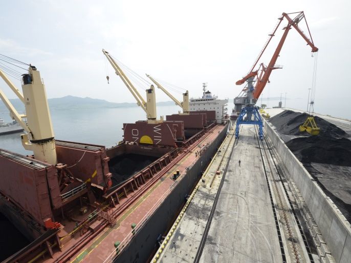 A cargo ship is loaded with coal during the opening ceremony of a new dock at the North Korean port of Rajin July 18, 2014. The dock was jointly built with Russia after last year's completion of a railway link to North Korea, holding out the prospect of increased trade for the reclusive nation with its biggest neighbours after years of international sanctions. Picture taken July 18, 2014. REUTERS/Yuri Maltsev (NORTH KOREA - Tags: POLITICS BUSINESS TRANSPORT MARITIME)