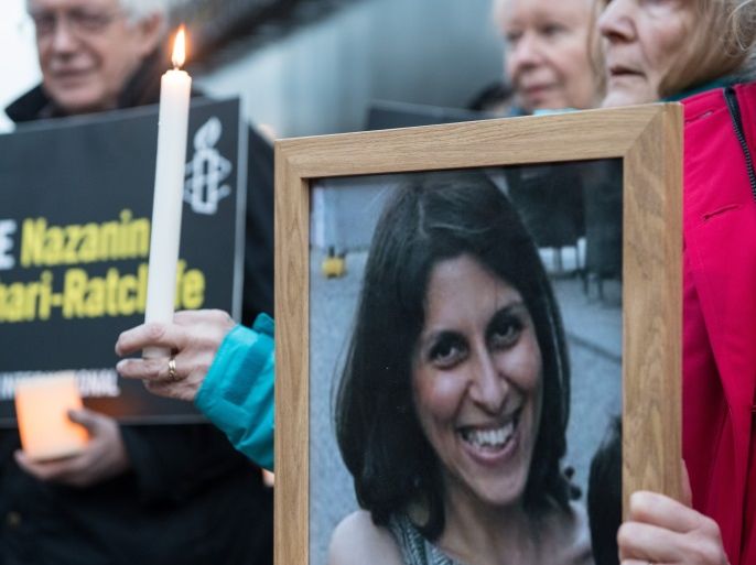 LONDON, ENGLAND - JANUARY 16: Supporters hold a photo of Nazanin Zaghari-Ratcliffe, candles and signs during a vigil for British-Iranian mother, Nazanin Zaghari-Ratcliffe, imprisoned in Tehran outisde the Iranian Embassy on January 16, 2017 in London, England. Charity worker Nazanin Zaghari-Ratcliffe was jailed for five years in September 2016 for allegedly attempting to overthrow the Iranian government. The vigil, being held outside the Iranian Embassy in London marks