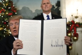 With Vice Pence Mike Pence looking on, U.S. President Donald Trump displays an executive order after he announced the U.S. would Jerusalem as the capital of Israel, in the Diplomatic Reception Room of the White House in Washington, U.S., December 6, 2017. REUTERS/Kevin Lamarque