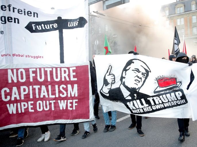 Protesters with banners march during an anti-WEF and anti-U.S. President Donald Trump demonstration, ahead of Trump's visit to the World Economic Forum (WEF), in Bern, Switzerland, January 13, 2018. REUTERS/Arnd Wiegmann