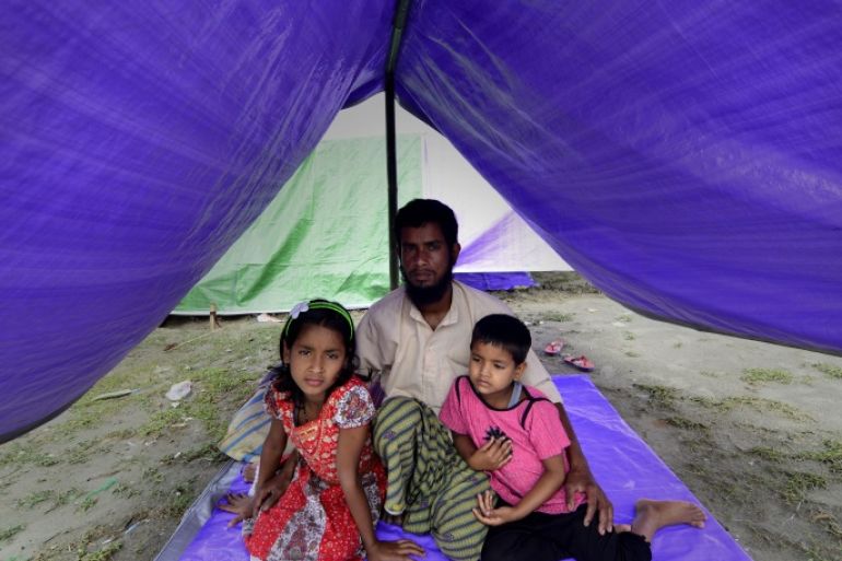 epa04195204 Saidul Islam along with his two daughters Sazda Khatu and Mazda Khatut take shelter in relief camp after their mother was killed by the militants in Narayanguri village in Baksa district of Assam state, about 180 km from Guwahati city, India, 07 May 2014.