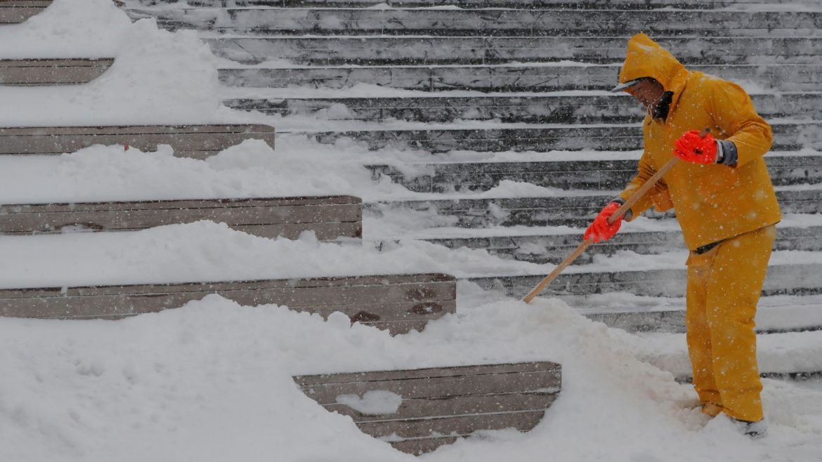 A worker clears the snow from a staircase during Storm Grayson in New York, U.S., January 4, 2018.  REUTERS/Lucas Jackson
