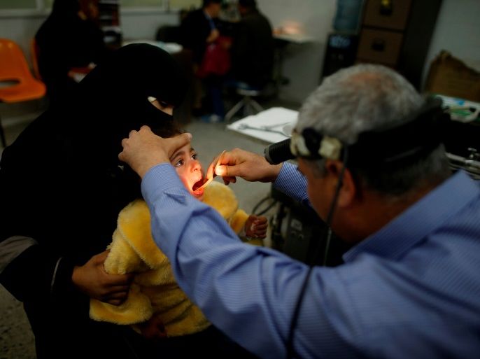 Palestinian girl Nour Seyam, 3, who suffers from tonsillitis, is checked by a doctor at an outpatient clinic at Shifa hospital, Gaza's largest public medical facility, in Gaza City, March 29, 2017. REUTERS/Mohammed Salem SEARCH