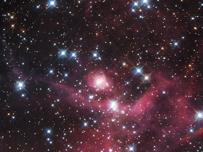 A small part of the Large Magellanic Cloud, one of the closest galaxies to our own, is seen in an undated image taken from NASA's Hubble telescope released February 28, 2014. The collection of small baby stars, most weighing less than the sun, form a young stellar cluster known as LH63. The burning red intensity of the nebulae at the bottom of the picture illuminates wisps of gas and dark dust, each spanning many light-years. REUTERS/NASA/ESA/Handout via Reuters (OUTER SPACE - Tags: SCIENCE TECHNOLOGY) ATTENTION EDITORS - THIS IMAGE WAS PROVIDED BY A THIRD PARTY. FOR EDITORIAL USE ONLY. NOT FOR SALE FOR MARKETING OR ADVERTISING CAMPAIGNS. THIS PICTURE IS DISTRIBUTED EXACTLY AS RECEIVED BY REUTERS, AS A SERVICE TO CLIENTS