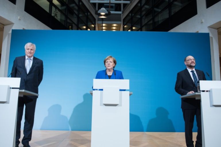 BERLIN, GERMANY - JANUARY 12: German Chancellor and head of the German Christian Democrats (CDU) Angela Merkel (C), Bavarian Governor and leader of the Bavarian Christian Democrats (CSU) Horst Seehofer (L) and leader of the German Social Democrats (SPD) Martin Schulz make a statement following all-night preliminary coalition talks on January 12, 2018 in Berlin, Germany. The leaders signalled the talks have ended in success. The parties will likely soon beging the arduou