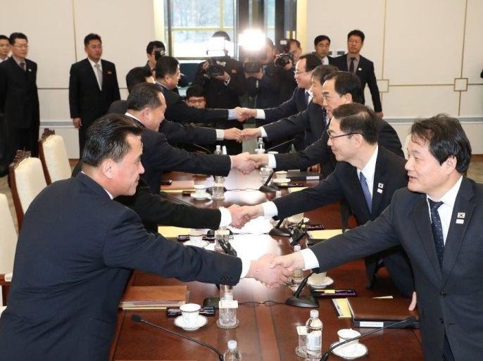 South and North Korean delegations attend their meeting at the truce village of Panmunjom in the demilitarised zone separating the two Koreas, South Korea, January 9, 2018. Yonhap via REUTERS ATTENTION EDITORS - THIS IMAGE HAS BEEN SUPPLIED BY A THIRD PARTY. SOUTH KOREA OUT. NO RESALES. NO ARCHIVE
