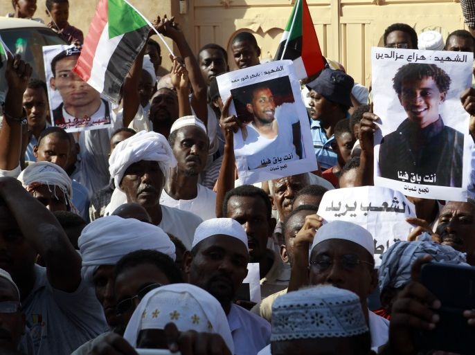 People carry pictures depicting whom they say are victims of the government's deadly crackdown on protesters against subsidy cuts late last month, during a demonstration after Friday prayers in north Khartoum October 4, 2013. REUTERS/Stringer (SUDAN - Tags: POLITICS CIVIL UNREST)