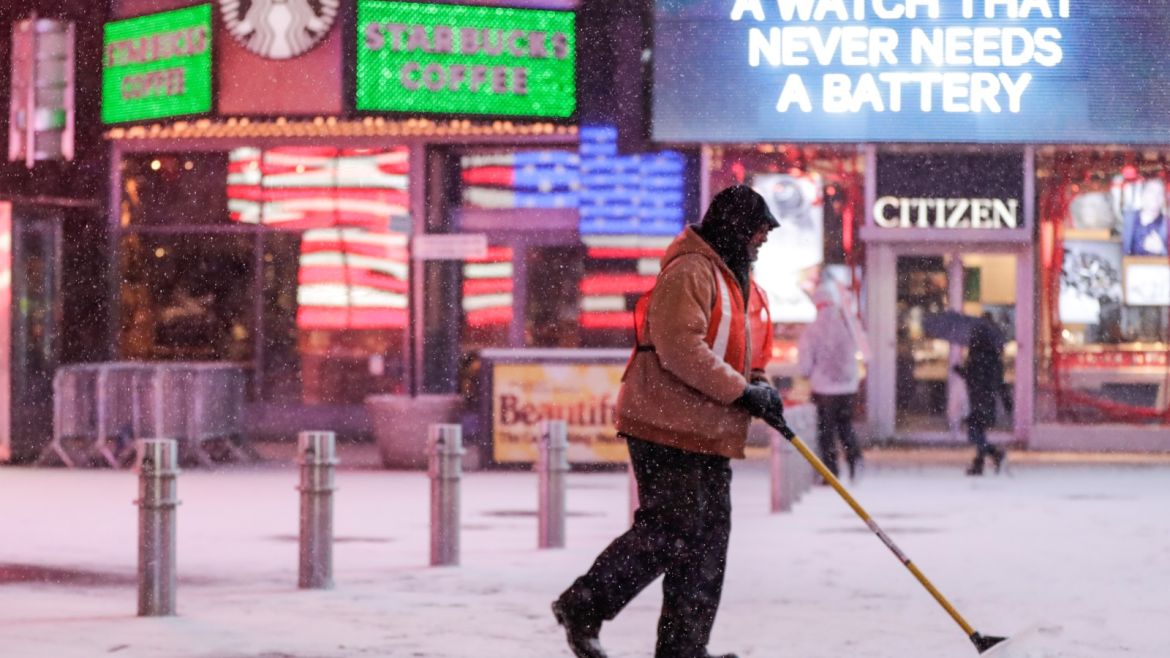 A worker removes snow during a snowstorm in Times Square in Manhattan, New York, U.S. January 4, 2018. REUTERS/Jeenah Moon