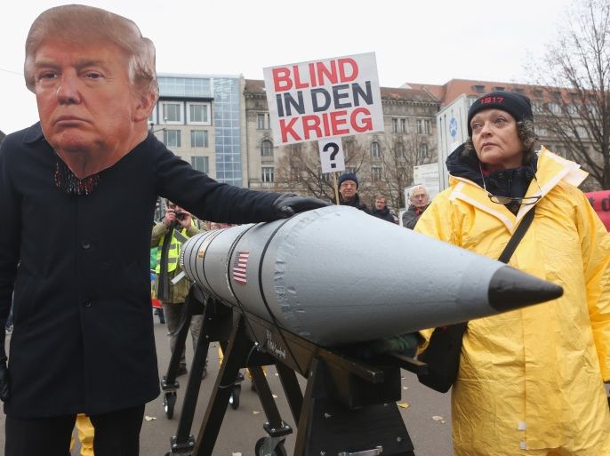 BERLIN, GERMANY - NOVEMBER 18: An activist with a mask of U.S. President Donald Trump marches with a model of a nuclear rocket during a demonstration against nuclear weapons on November 18, 2017 in Berlin, Germany. About 700 demonstrators protested against the current escalation of threat of nuclear attack between the United States of America and North Korea. The event was organized by peace advocacy organizations including the International Campaign to Abolish Nuclear Weapons (ICAN), which won the Nobel Prize for Peace this year. (Photo by Adam Berry/Getty Images)