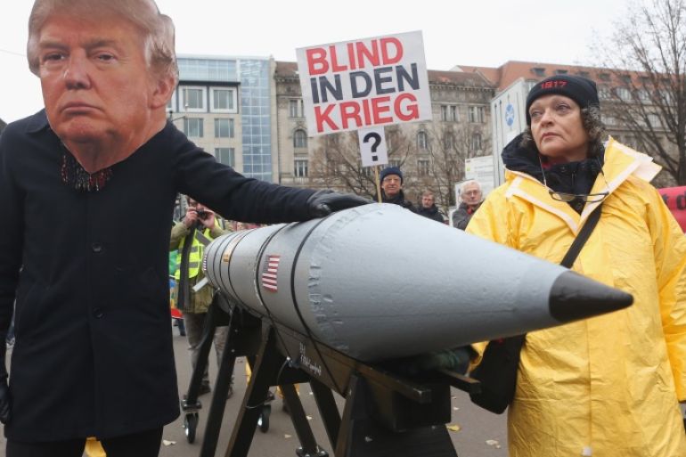 BERLIN, GERMANY - NOVEMBER 18: An activist with a mask of U.S. President Donald Trump marches with a model of a nuclear rocket during a demonstration against nuclear weapons on November 18, 2017 in Berlin, Germany. About 700 demonstrators protested against the current escalation of threat of nuclear attack between the United States of America and North Korea. The event was organized by peace advocacy organizations including the International Campaign to Abolish Nuclear Weapons (ICAN), which won the Nobel Prize for Peace this year. (Photo by Adam Berry/Getty Images)