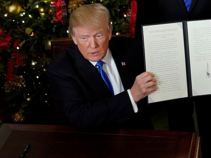 U.S. President Donald Trump displays an executive order after he announced the U.S. would recognize Jerusalem as the capital of Israel, in the Diplomatic Reception Room of the White House in Washington, U.S. December 6, 2017. REUTERS/Jonathan Ernst