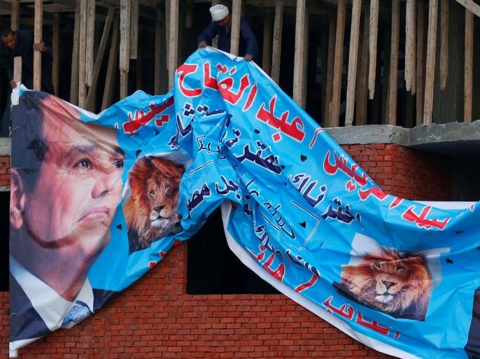 Egyptians put a huge poster on a new building for Egyptian President Abdel Fattah al-Sisi which reads