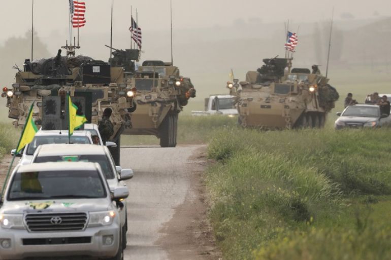 Kurdish fighters from the People's Protection Units (YPG) head a convoy of U.S military vehicles in the town of Darbasiya next to the Turkish border, Syria April 28, 2017. REUTERS/Rodi Said