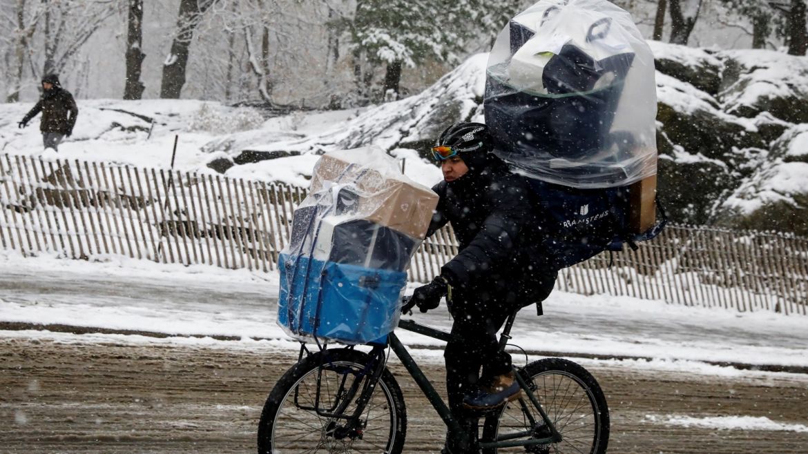 A delivery person rides his bike as the snow falls in Central Park during a pre-winter storm in New York City, U.S., December 9, 2017. REUTERS/Brendan McDermid