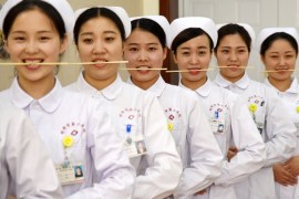 Nurses practice smiling with chopsticks in their mouths at a hospital in Handan, Hebei province, China, May 8, 2017. REUTERS/Stringer ATTENTION EDITORS - THIS IMAGE WAS PROVIDED BY A THIRD PARTY. EDITORIAL USE ONLY. CHINA OUT. NO COMMERCIAL OR EDITORIAL SALES IN CHINA. TPX IMAGES OF THE DAY