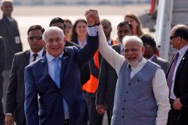 Israeli Prime Minister Benjamin Netanyahu and his Indian counterpart Narendra Modi raise their arms upon Netanyahu’s arrival at Air Force Station Palam in New Delhi, India, January 14, 2018. REUTERS/Adnan Abidi