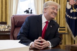 epaselect epa06403231 US President Donald J. Trump smiles while signing bills in the Oval Office of the White House in Washington, DC, USA, 22 December 2017. Trump signed the tax bill, a continuing resolution to fund the government, and a missile defense bill before leaving to spend Christmas in Mar-a-Lago, Florida. EPA-EFE/MICHAEL REYNOLDS