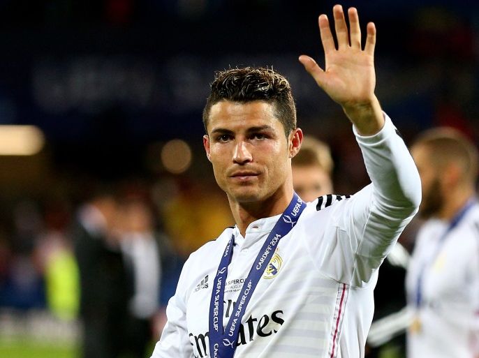 CARDIFF, WALES - AUGUST 12: Cristiano Ronaldo of Real Madrid waves to the fans following his team's 2-0 victory during the UEFA Super Cup between Real Madrid and Sevilla FC at Cardiff City Stadium on August 12, 2014 in Cardiff, Wales. (Photo by Clive Mason/Getty Images)